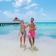 Couple walking beach Cozumel all inclusive beach club