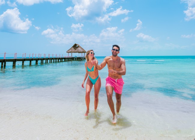 Couple walking beach Cozumel all inclusive beach club